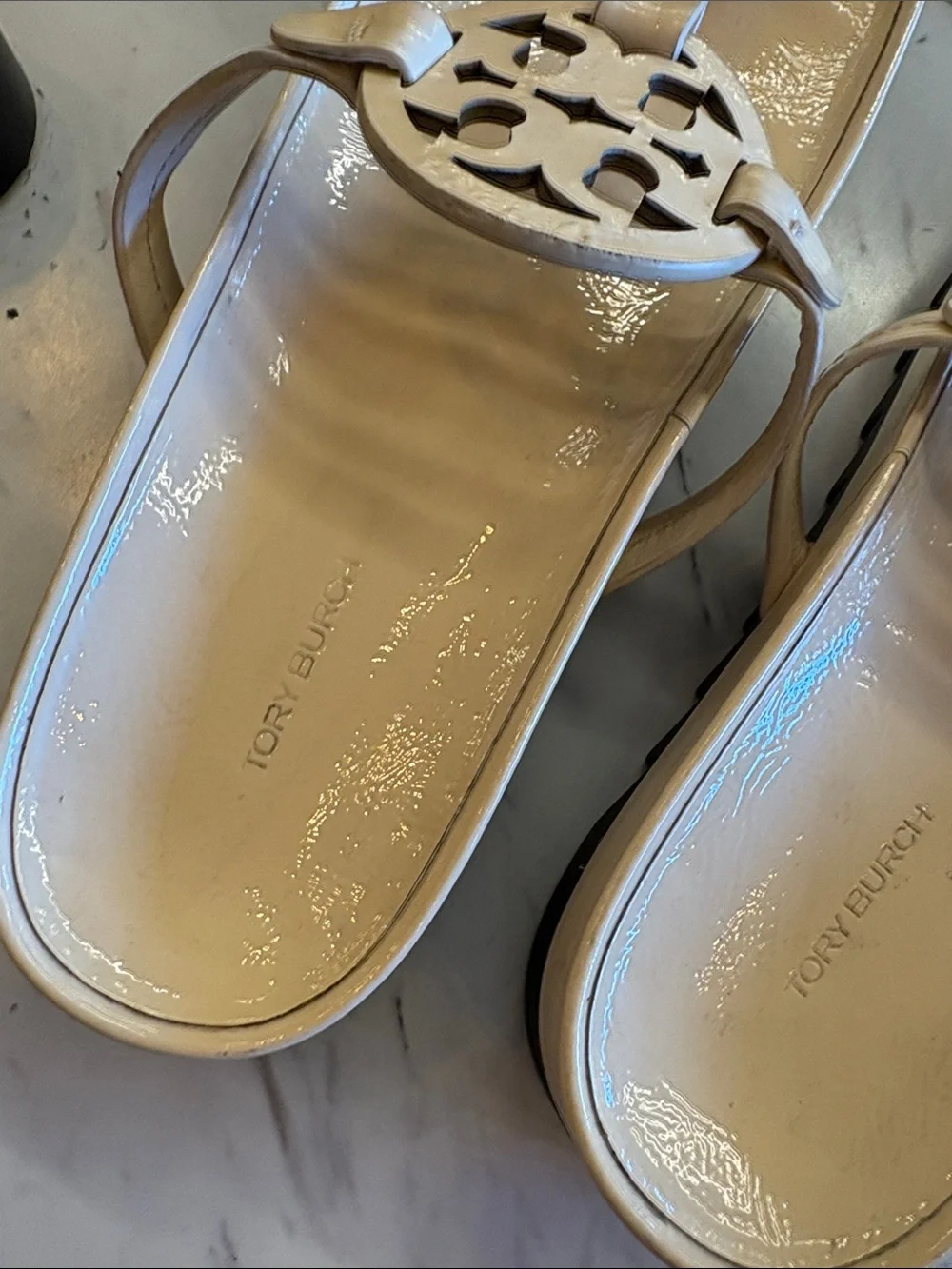 Tory Burch Patent Logo Thong Sandals in Light Beige with a chunky heel.
